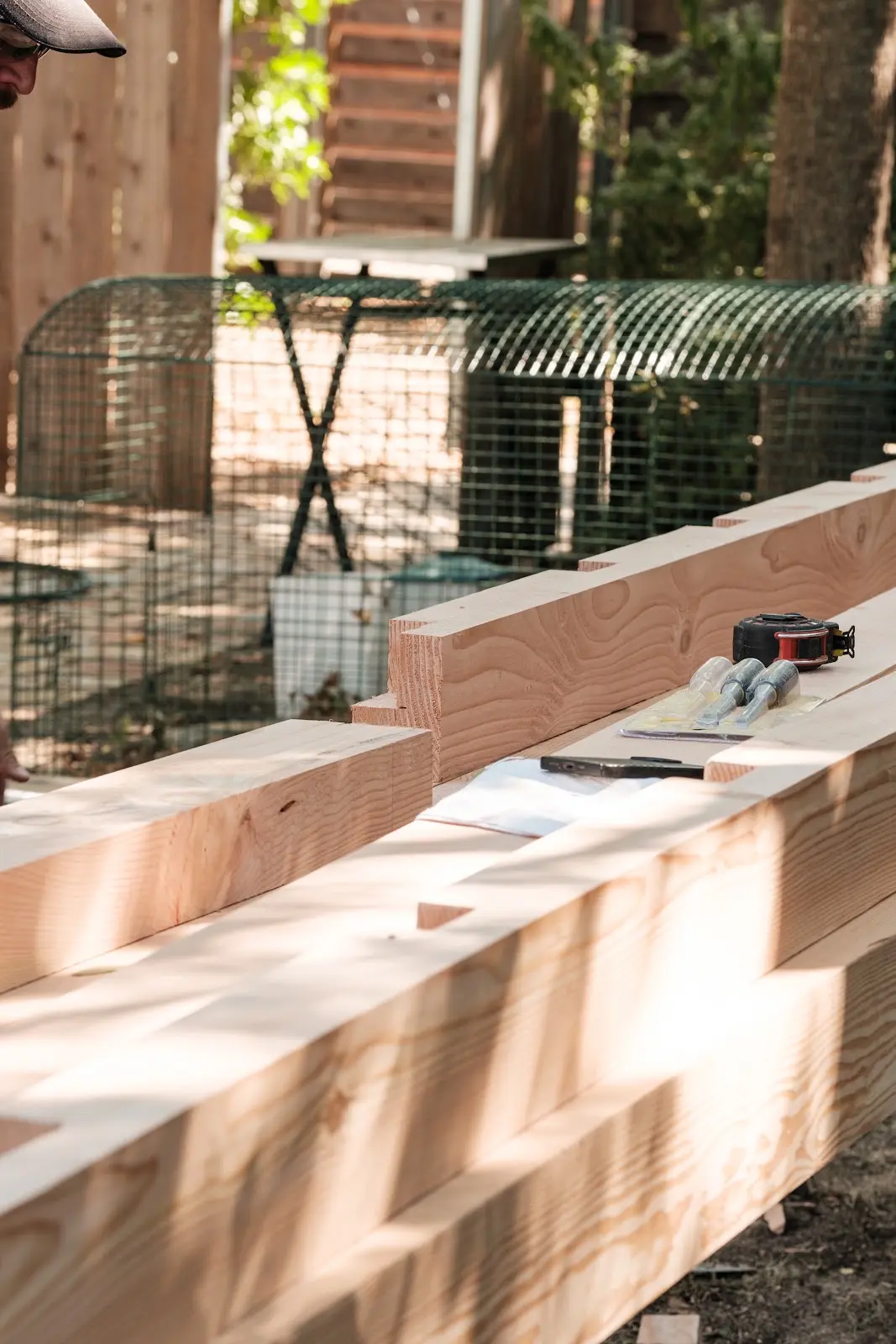 Notched wood components with chisels and a tape measure during construction